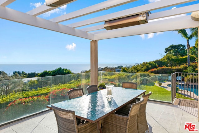 view of patio with a water view and a pergola