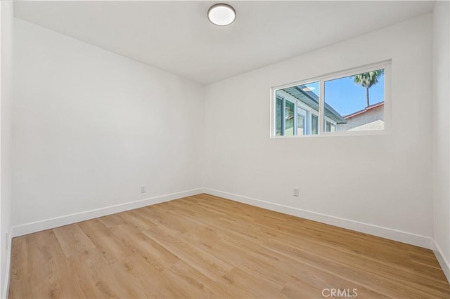 unfurnished room with hardwood / wood-style floors