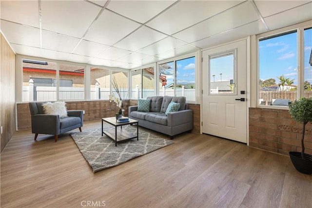 sunroom with a healthy amount of sunlight and a drop ceiling