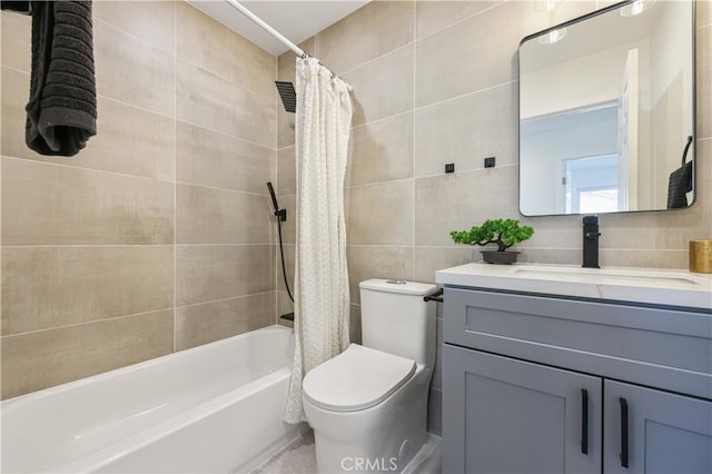 full bathroom with vanity, tile walls, shower / bathtub combination with curtain, and toilet