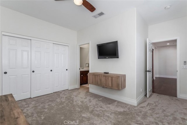 unfurnished bedroom featuring light carpet, ceiling fan, and a closet