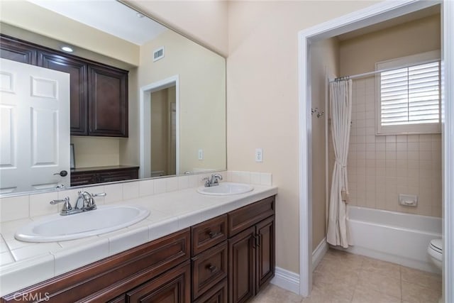 full bathroom with vanity, tile patterned floors, toilet, and shower / tub combo with curtain