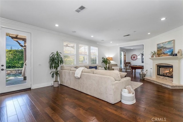 living room featuring crown molding, a high end fireplace, and dark hardwood / wood-style floors