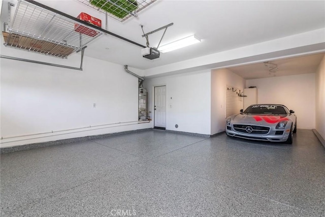 garage with a garage door opener and water heater