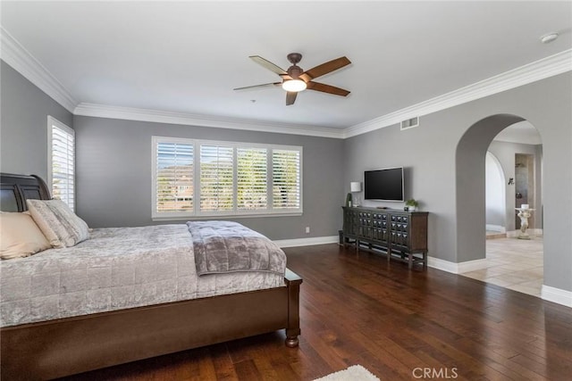 bedroom featuring ceiling fan, ornamental molding, and wood-type flooring