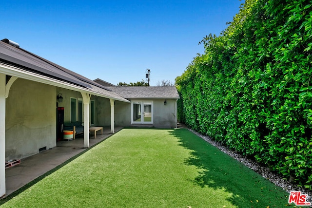 view of yard featuring french doors