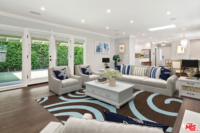 living room featuring ornamental molding, dark hardwood / wood-style flooring, and a skylight