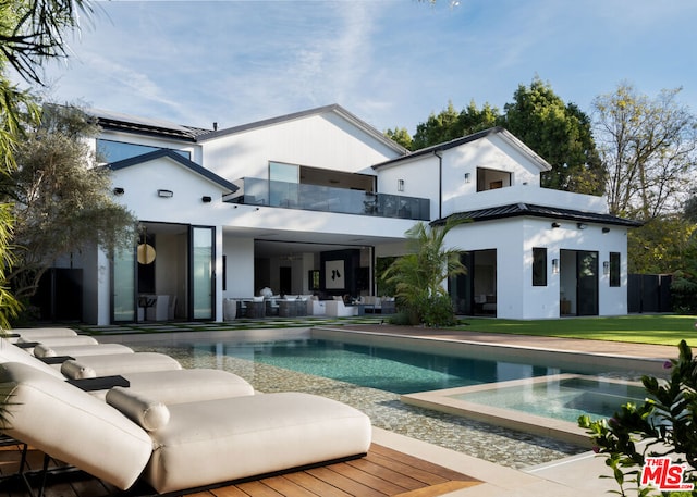 back of house featuring a patio and a balcony