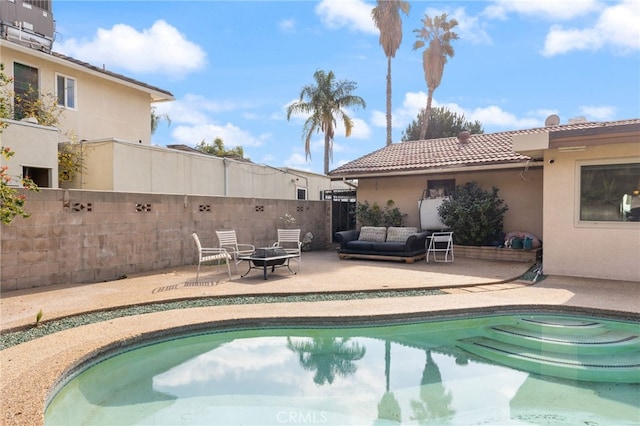 view of swimming pool featuring a patio area and a fire pit