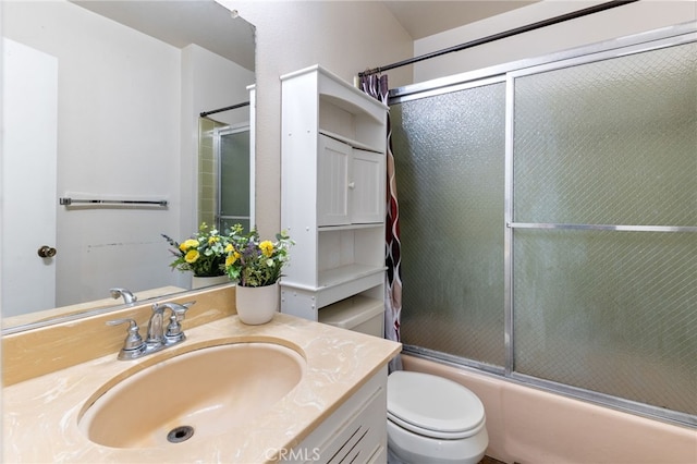 full bathroom featuring toilet, vanity, and shower / bath combination with glass door