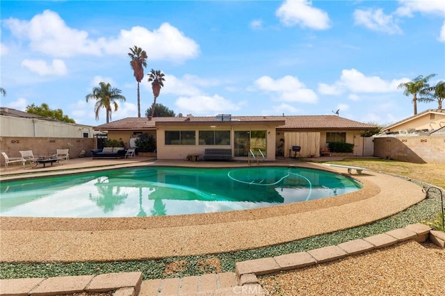 view of swimming pool with a diving board and a patio area