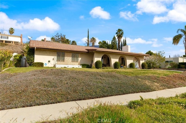 ranch-style home with a front lawn