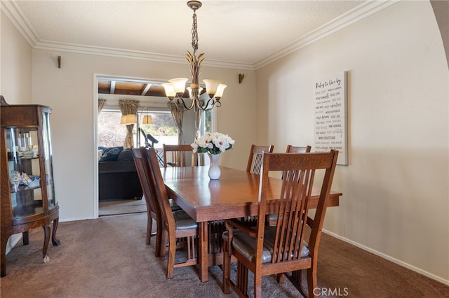 dining space featuring dark carpet, ornamental molding, and a chandelier