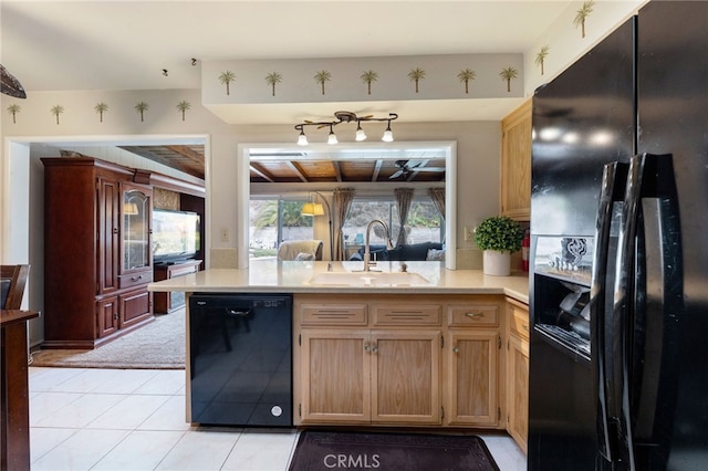 kitchen featuring light tile patterned flooring, sink, kitchen peninsula, and black appliances