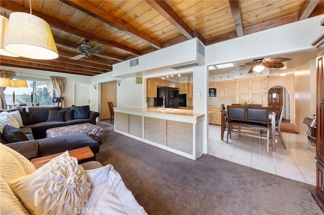 carpeted living room with ceiling fan, beam ceiling, and wooden ceiling