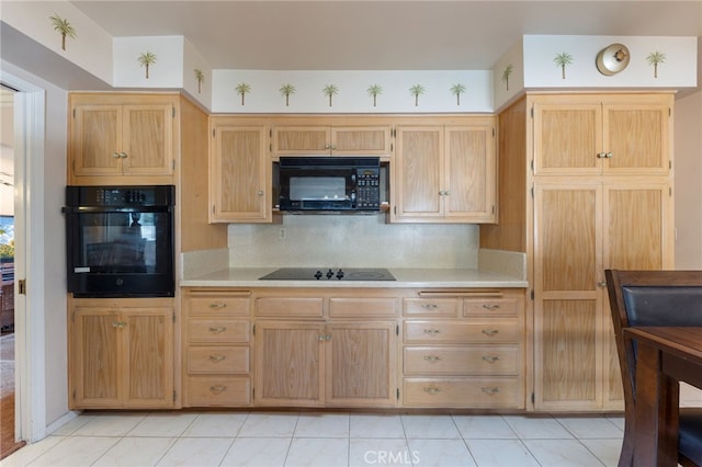 kitchen with backsplash, light brown cabinetry, and black appliances