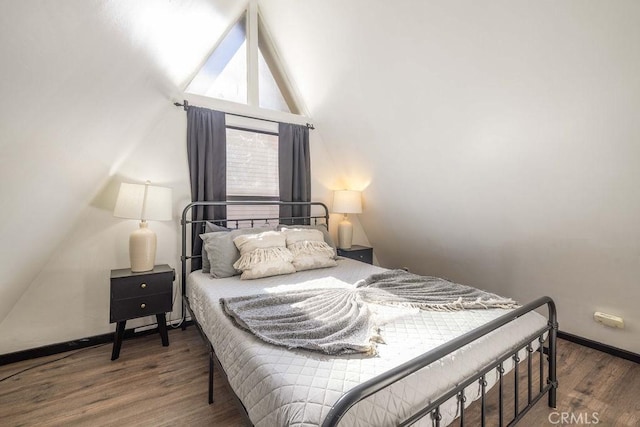 bedroom featuring vaulted ceiling and dark hardwood / wood-style floors