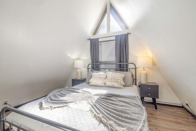 bedroom with vaulted ceiling and wood-type flooring