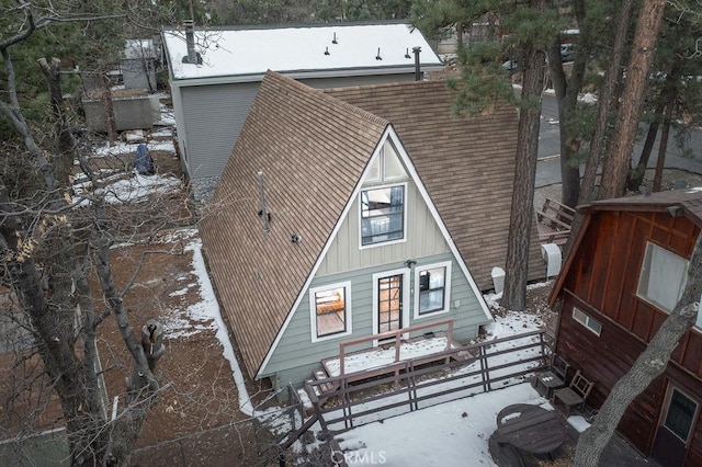 view of snow covered rear of property