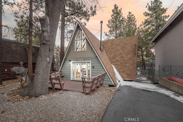 back house at dusk featuring french doors