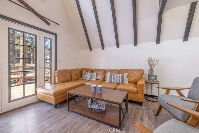 living room with wood-type flooring and vaulted ceiling with beams