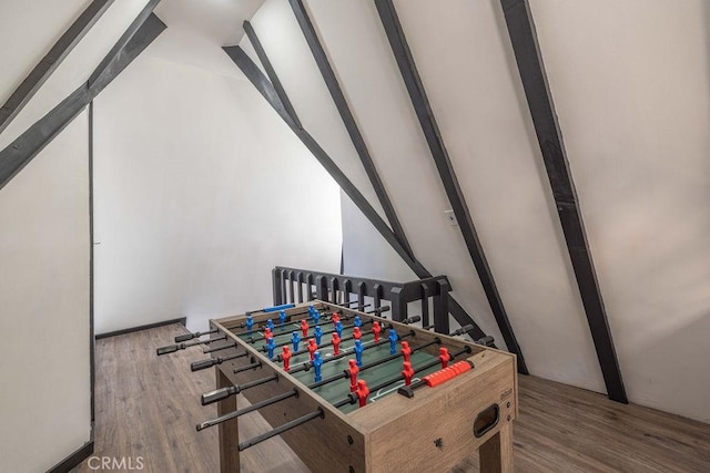 rec room featuring hardwood / wood-style floors and vaulted ceiling with beams