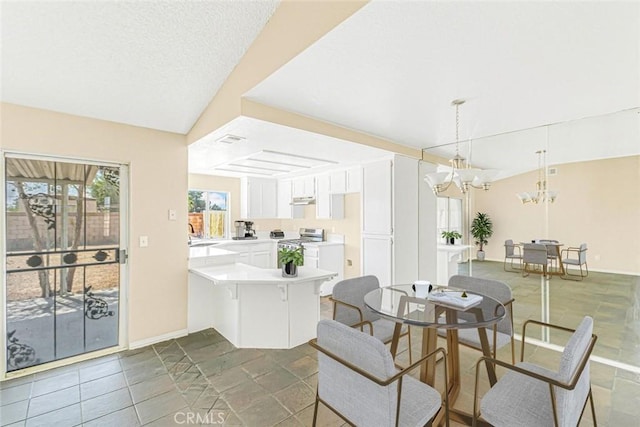 dining area with vaulted ceiling and a notable chandelier