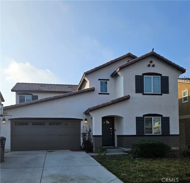 view of front of property with a garage and a front lawn