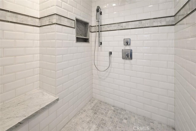 bathroom with tiled shower