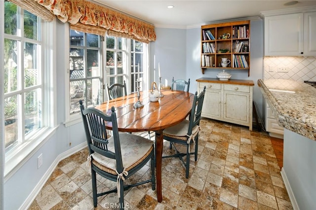 dining room featuring crown molding