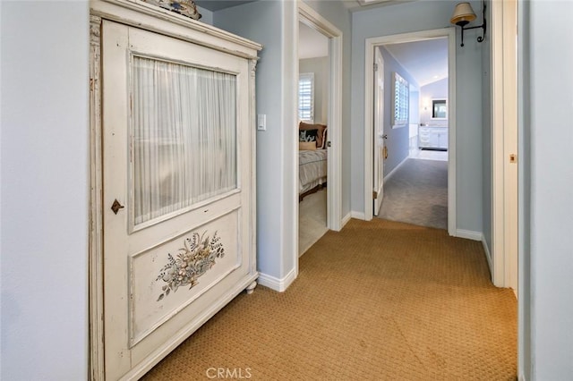 hall featuring light colored carpet