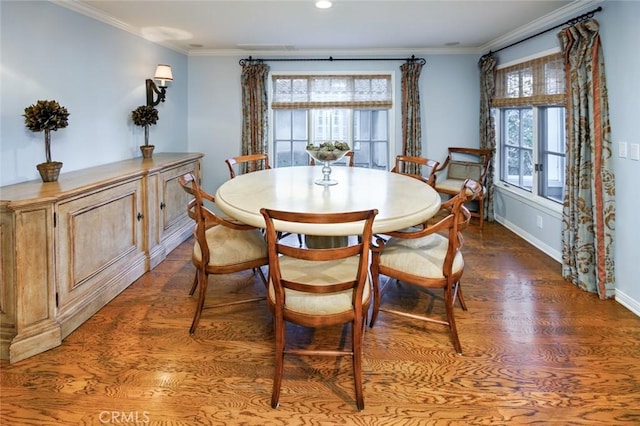 dining room with crown molding and hardwood / wood-style flooring