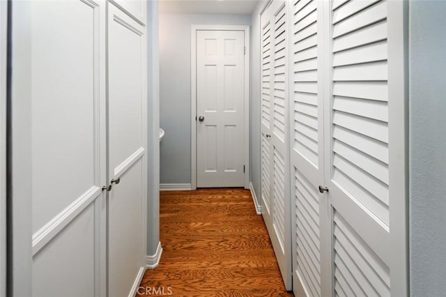 hallway with dark hardwood / wood-style floors