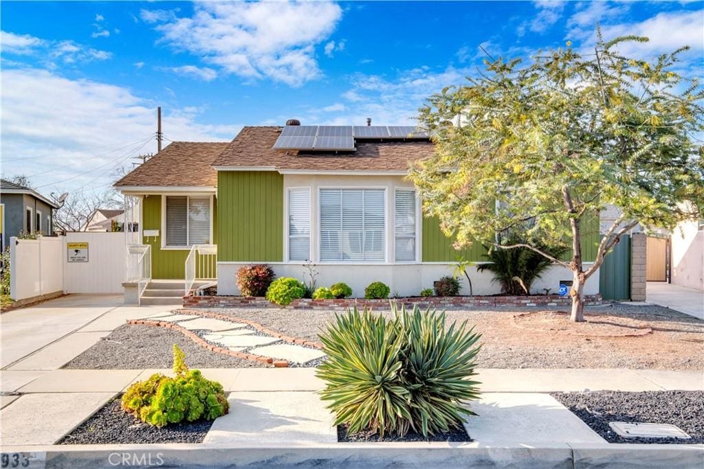 bungalow-style home with central AC and solar panels