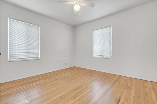 spare room featuring light hardwood / wood-style flooring and ceiling fan