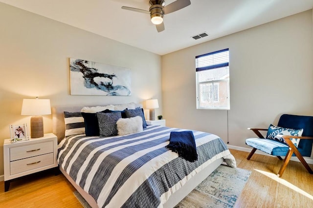 bedroom with ceiling fan and light hardwood / wood-style floors