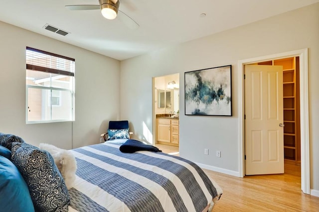 bedroom featuring ceiling fan, sink, and light hardwood / wood-style floors