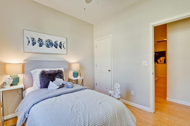 bedroom with ceiling fan and light wood-type flooring