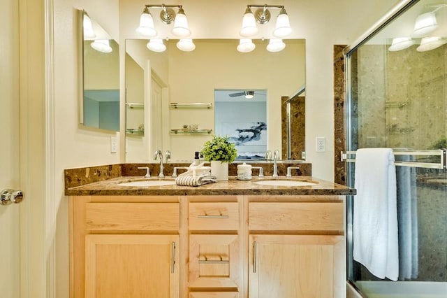 bathroom with vanity, ceiling fan, and walk in shower