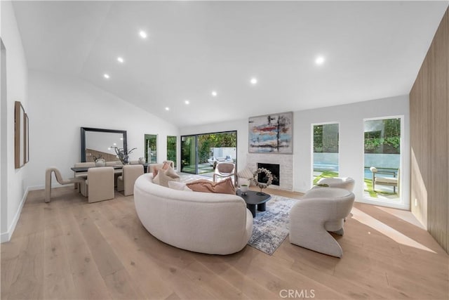 living room with high vaulted ceiling and light wood-type flooring