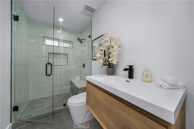 bathroom with vanity, an enclosed shower, and toilet