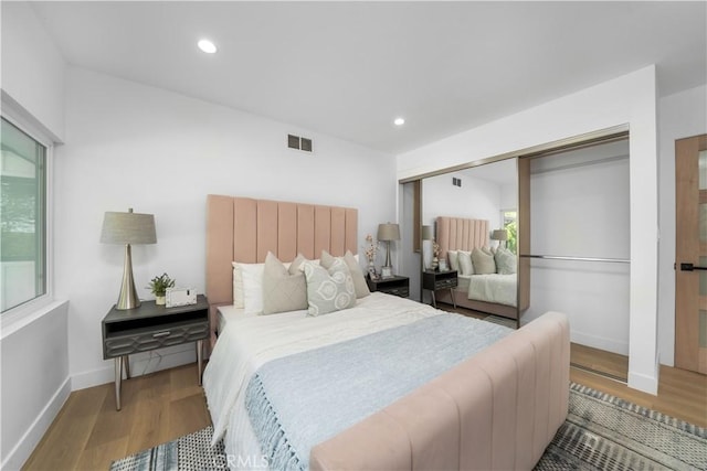 bedroom featuring light hardwood / wood-style floors and a closet