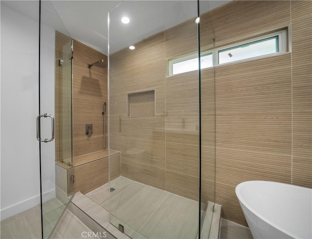 bathroom featuring shower with separate bathtub and tile patterned flooring