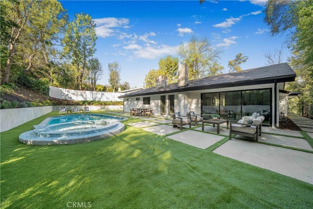 exterior space featuring a pool with hot tub, an outdoor living space, and a patio