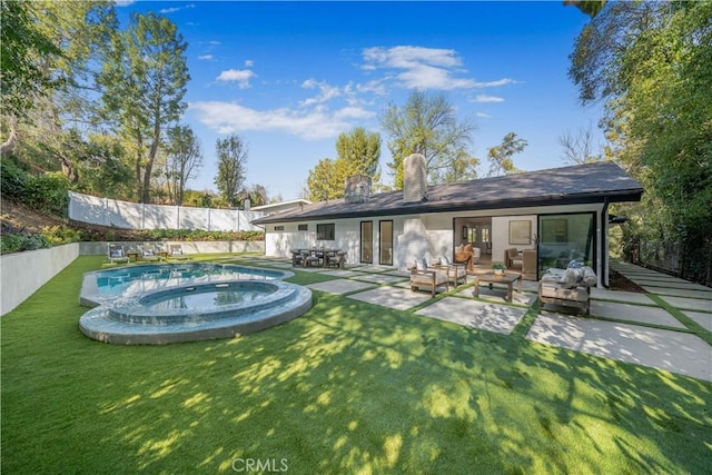 back of house featuring a patio, a yard, an outdoor hangout area, and a pool with hot tub