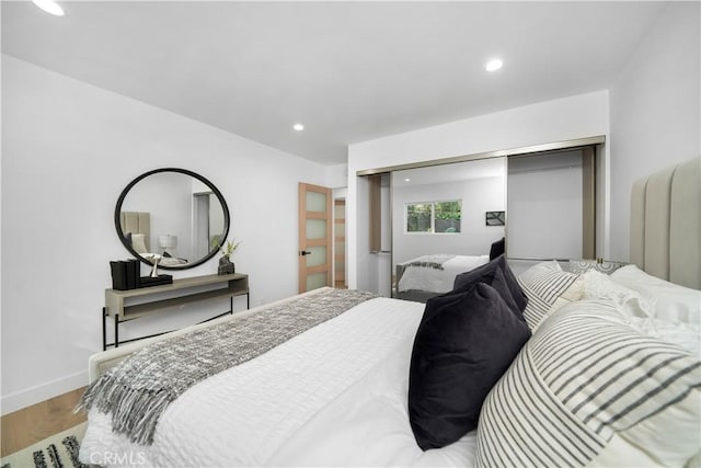 bedroom featuring hardwood / wood-style floors and a closet