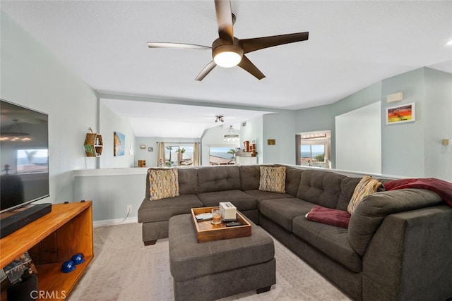 living room with ceiling fan and light colored carpet