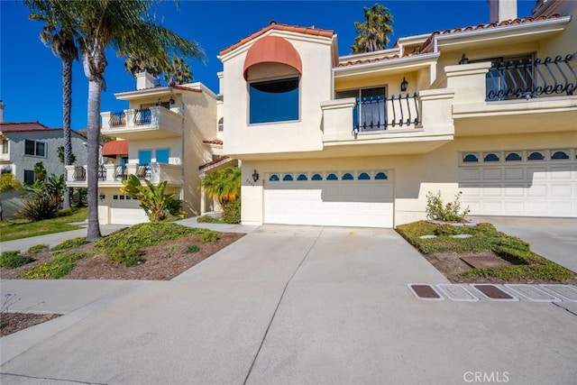 view of property featuring a balcony and a garage