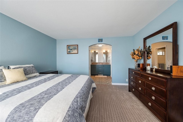 carpeted bedroom featuring ensuite bathroom