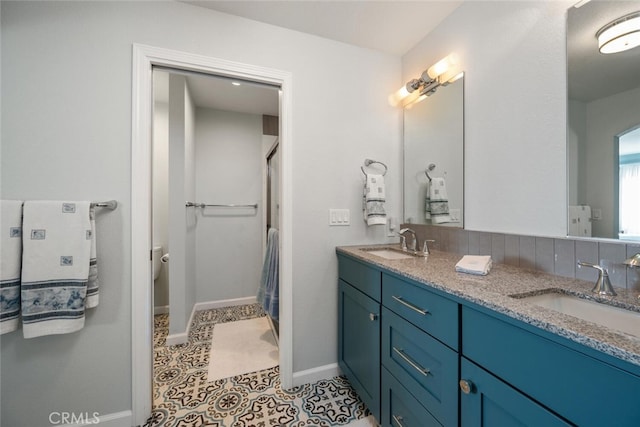 bathroom featuring vanity, toilet, and tile patterned flooring